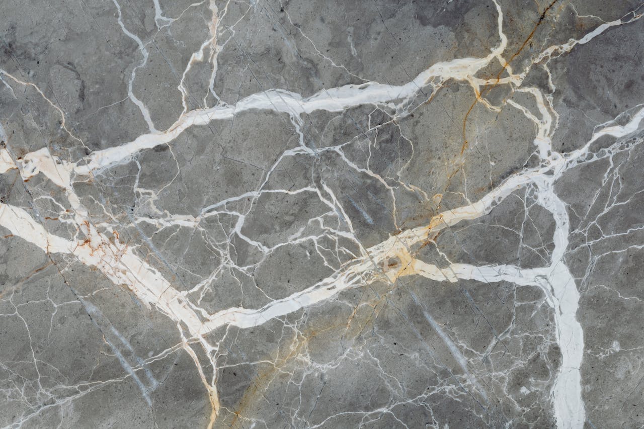 services-02 Detailed close-up of natural marble surface showcasing intricate vein patterns for design projects.
